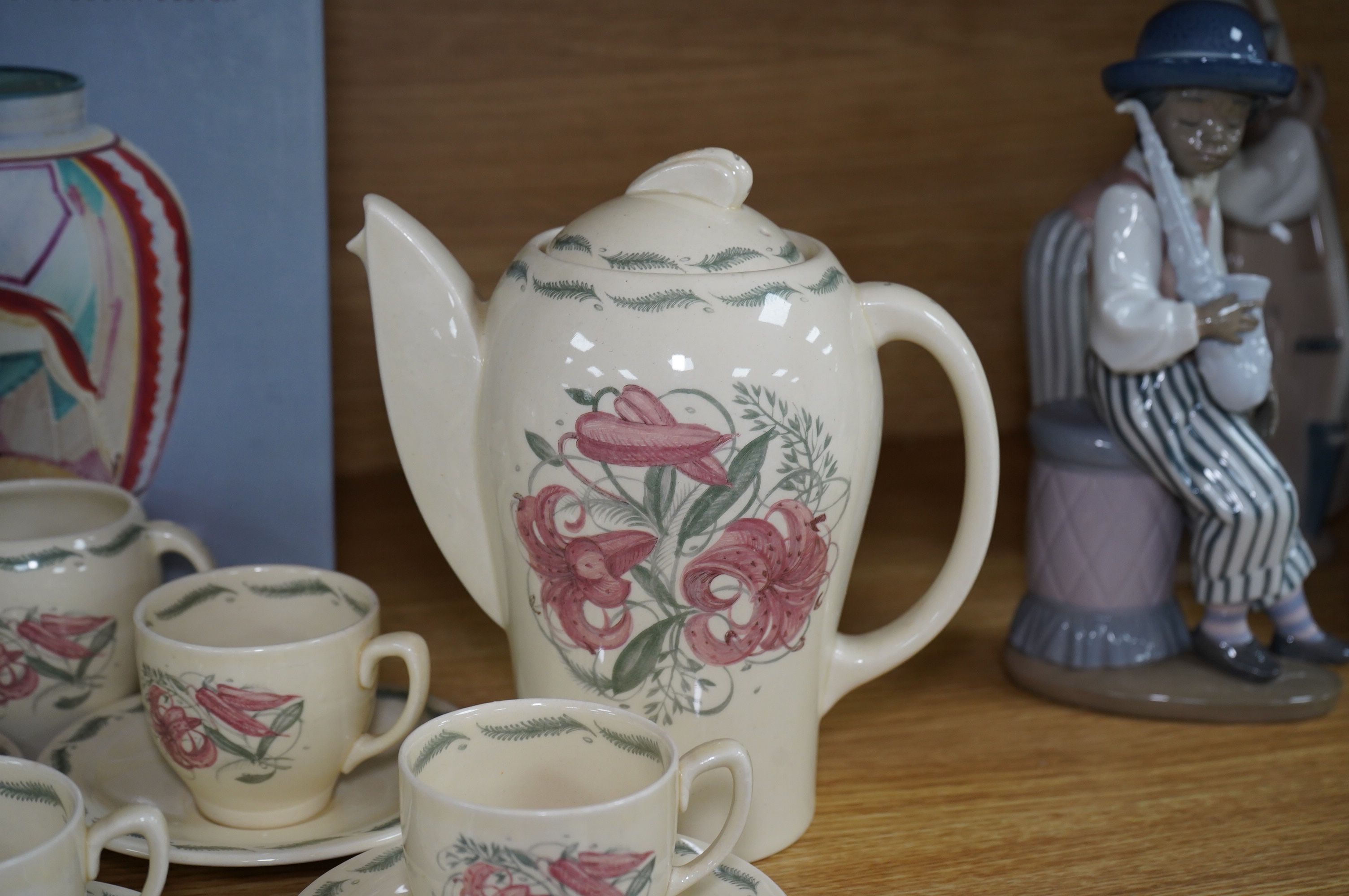 A Susie Cooper style 'Tiger Lily' pattern teaset, possibly by Wood & Co., a Susie Cooper reference book and a later painted Falcon shape coffee pot. Condition - good